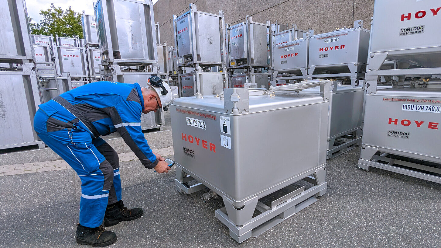 employee stands in front of a Meter Cube and scans it