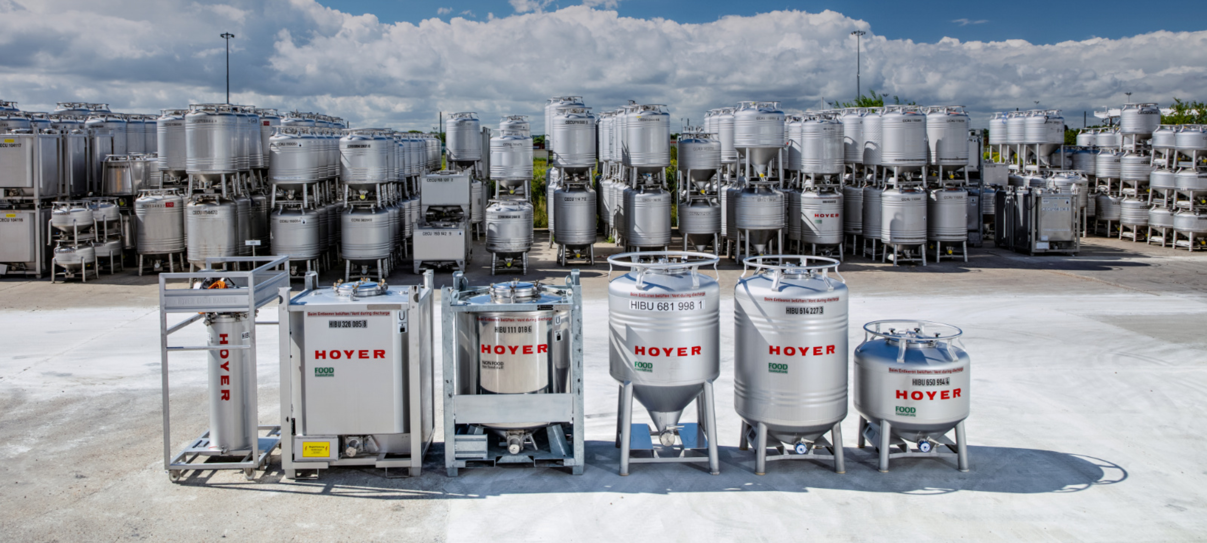 IBC-totes-food-and-non-food-HOYER-Group-in-background-in-depot Food and non-food IBC totes of the HOYER Group stand stacked up in the depot.