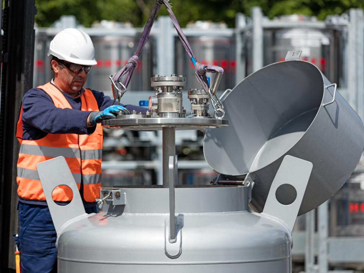 Employee inserts an agitator into an IBC tote